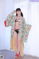 A woman in a kimono is posing for a picture.