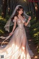 A woman in a wedding dress walking down a path in the woods.